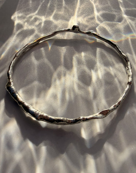 Silver bracelet on a textured surface