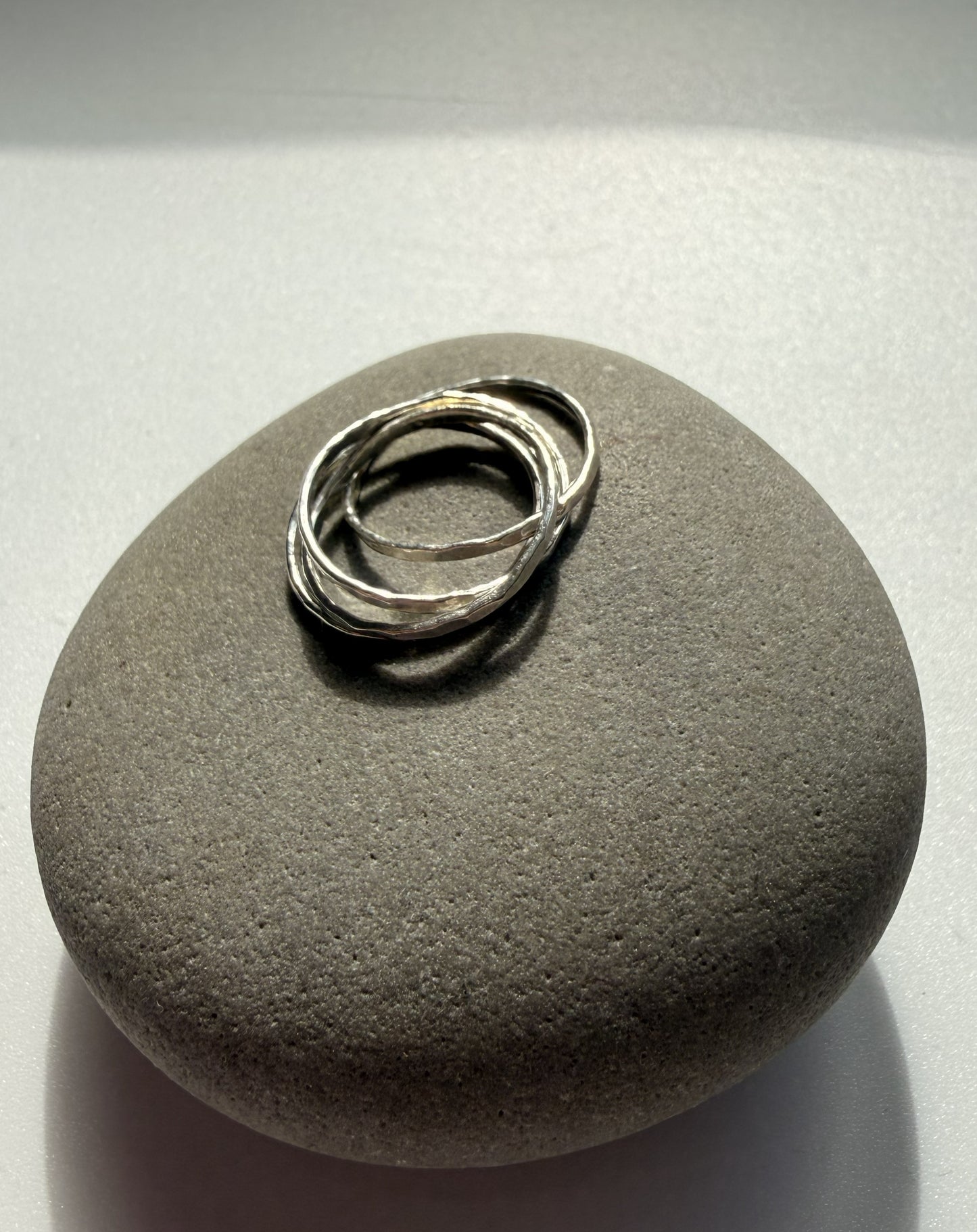 Silver ring on a textured gray stone